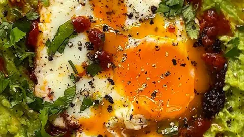 Harissa breakfast tacos close up, with an egg in the middle.