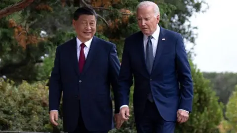 Getty Images US President Joe Biden (R) and Chinese President Xi Jinping walk together after a meeting during the Asia-Pacific Economic Cooperation (APEC) Leaders' week in Woodside, California on November 15, 2023. 