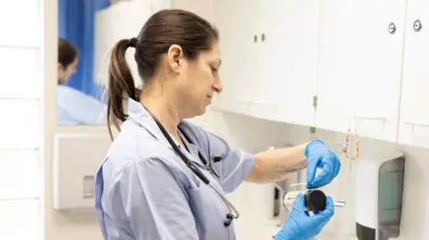 Hands in gloves handling a test result - stock photo