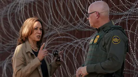 Reuters Democratic presidential candidate and U.S. Vice President Kamala Harris with a Border Patrol agent tours the border wall near Tucson in Douglas, Arizona, U.S., September 27, 2024