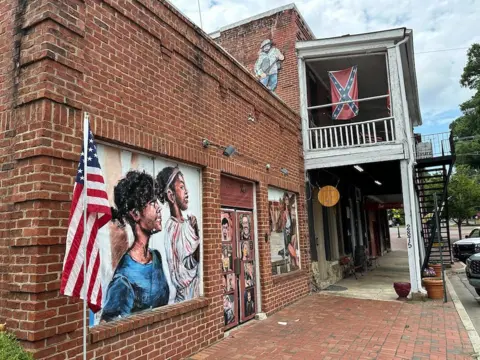 A downtown street in Kennesaw, where the American flag hangs - and the Confederate flag