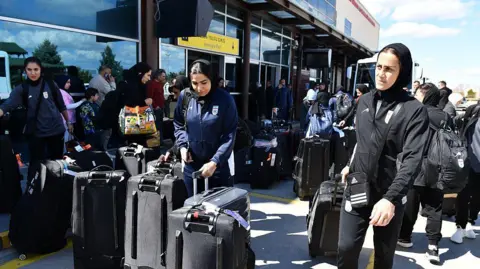 Getty Images Iranian women's football team arrives at the Igdir airport near the Iranian border.
