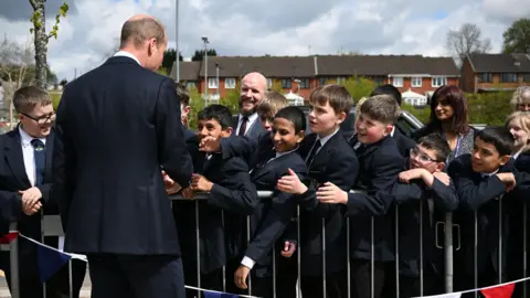 PA Media Prince William meeting a group of school pupils