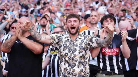 Notts County fans celebrate in the stands after their first goal during the Sky Bet League Two play-off final at Wembley Stadium.