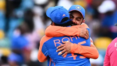 Getty Images India's captain Rohit Sharma and Virat Kohli celebrate after winning ICC men's Twenty20 World Cup 2024 final cricket match between India and South Africa at Kensington Oval in Bridgetown, Barbados, on June 29, 2024. (Photo by Chandan Khanna / AFP) (Photo by CHANDAN KHANNA/AFP via Getty Images)