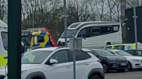 David Cardwell A white motorhome in a police compound in Glasgow. There are other vehicles, including a white car, in the foreground.