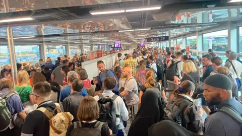 A large queue of people in an airport