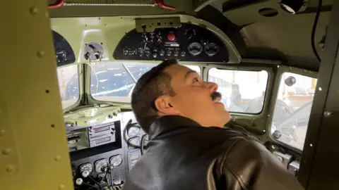 One of the US Air Force visitors looks around the inside of the wartime plane.
