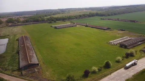 The site as it is now with three old chicken sheds on the land