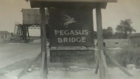 Margaret Brotheridge A black and white image of a "Pegasus Bridge" sign on the bridge