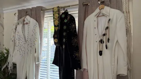 Elvis outfits hung up