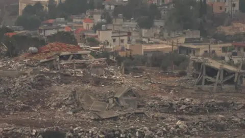 Destroyed buildings in the Lebanese village of Meiss el-Jabal, as seen from Kibbutz Menara in northern Israel (27 November 2024)