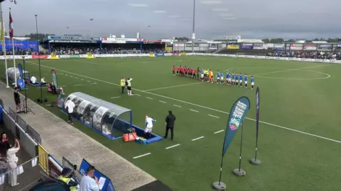 The junior teams of Rangers and Manchester United line up alongside each other on the pitch.