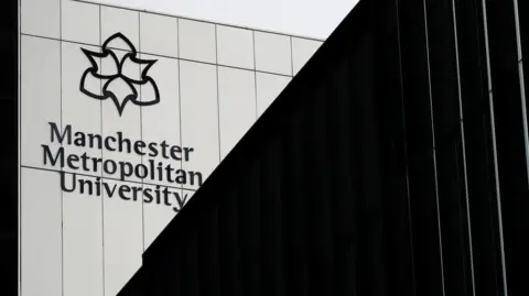 A general view of the Manchester Metropolitan University building, which is black and white.