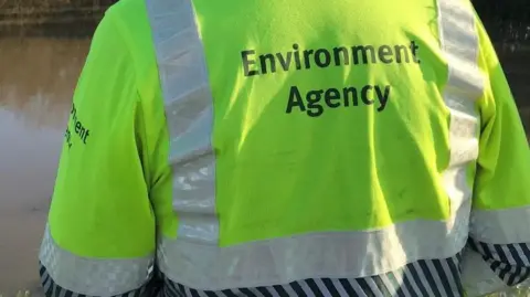 A hi-vis jacket with writing on from the rear.