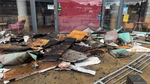 Rubble in front of the building after the fire. It is in front of the Costa Coffee shop.