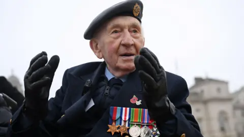 Reuters Joe Randall in an RAF beret and blazer with medals attacjed 