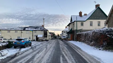 A rural road covered in snow and ice