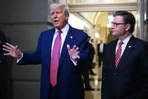 AFP via Getty Images US President Donald Trump and US Speaker of the House Mike Johnson (R-LA) speak to the press after a House GOP Conference Meeting at the US Capitol in Washington, DC on May 20, 2025. US President Donald Trump rallied Republicans on Capitol Hill Tuesday to back a so-called "big, beautiful bill" that is likely to increase the yawning budget deficit and cut health care for millions of Americans. (Photo by Mandel NGAN / AFP) (Photo by MANDEL NGAN/AFP via Getty Images)