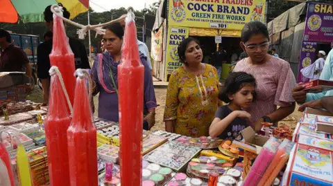 Getty Images People shop for candles and earthen lamps ahead of Diwali in Kolkata, on October 29, 2024