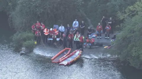 UKNIP Search and rescue teams at the side of a pond