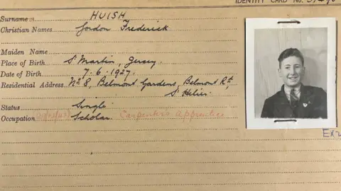 Jersey Heritage An ID card with a black and white photo of a young man with his name and address and other details on the left.