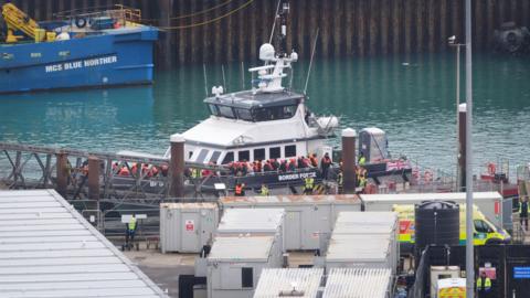 Migrants disembark from boat in Dover