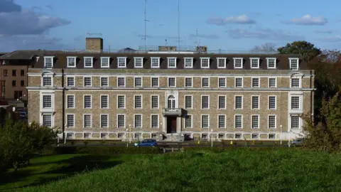 BBC A grand five-storey building with large windows.