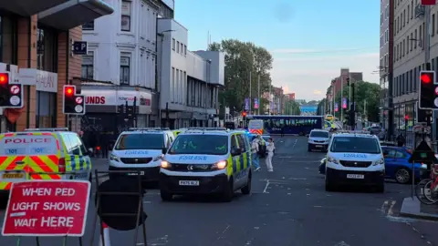 Police vehicles blocking a city centre road
