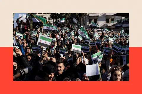 Reuters A crowd of people wave the Syrian flag