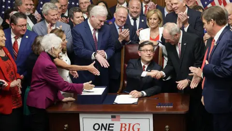 Getty Images U.S. Speaker of the House Rep. Mike Johnson (R-LA) celebrates with fellow House Republicans during an enrollment ceremony of H.R. 1, the One, Big, Beautiful Bill Act at the U.S. Capitol on July 3, 2025 in Washington, DC.