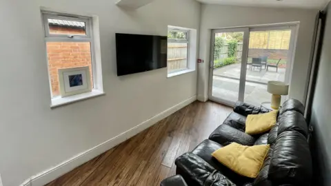 Supplied Sofa and television in living room