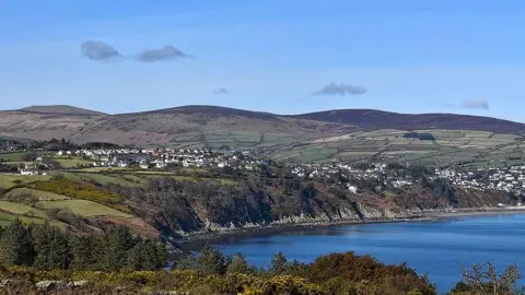 Laxey and Lonan seen from across Laxey Bay with hills in the background.