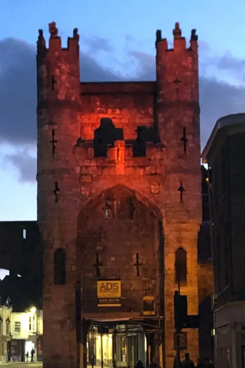Joseph Rowntree Foundation York castle illuminated in orange by night
