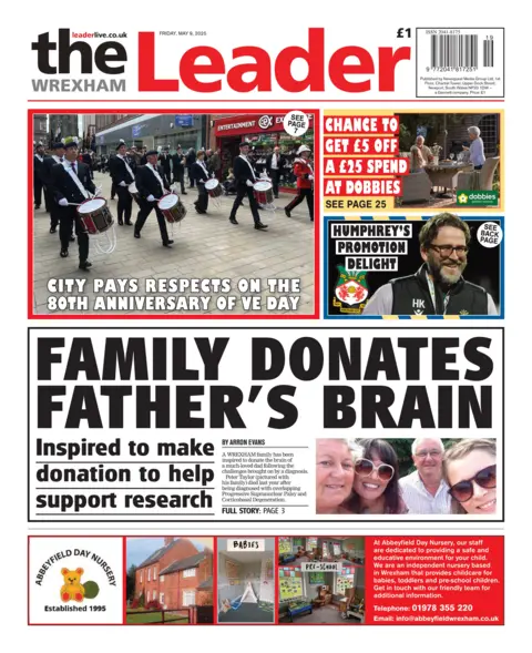Wrexham Leade Front page of the Wrexham Leader had a marching band playing on a street for victory in europe day and a picture of three women and an older man under the headline family donate father's brain. 