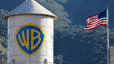 Getty Images The Warner Bros. logo is displayed at Warner Bros. Studio, alongside an American flag.