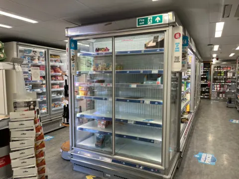 Image of an almost empty fridge in Brundall Co-op.