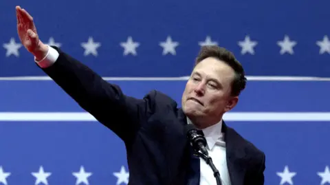 Musk gestures with one arm outstretched inside the Capital One arena in Washington on the inauguration day of Donald Trump