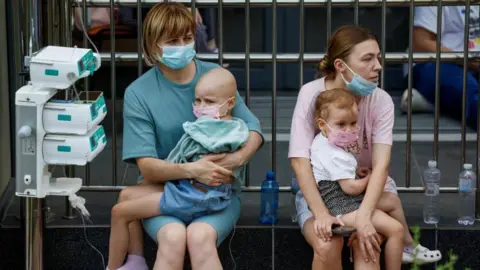 Reuters Children with IV drips sitting outside a Kyiv hospital