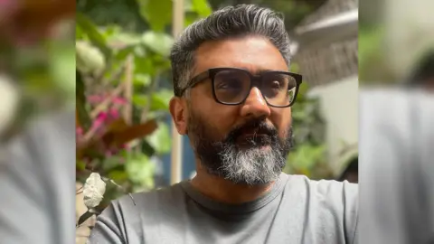 Kunal Shah, founder of Indian fintech start-up Cred, wearing a grey tee shirt and sporting sunglasses.