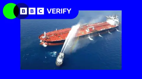 A graphical composite image showing the BBC Verify logo alongside a photo of a ship on fire on the Strait of Hormuz.