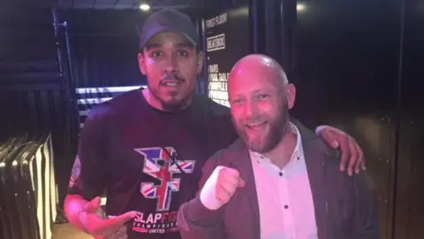 SlapFight UK Photo shows Josh Skeete and an unidentified man outside the arena at the BOx Park in Liverpool. 