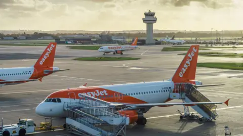 Getty Images Easyjet airplanes at London's Gatwick airport - SouthTerminal - stock photo