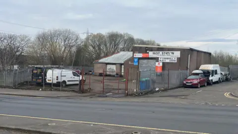 BBC Emergency services were called to reports of a van and two cars being set on fire at Lambhill Motors on Balmore Road at around 01:30.