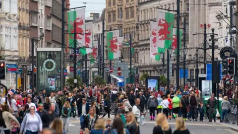 Getty Images City centre scene in Cardiff with people in St Mary Street, with Welsh flags flying