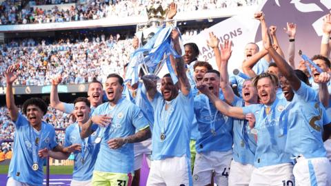 Manchester City players celebrate winning the Premier League at theEtihad Stadium