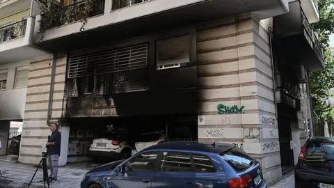 damage after a gas canister bomb exploded at the entrance of a building in Thessaloniki on July 1, 2026