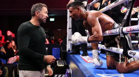 Bilal Fawaz speaks to Eddie Hearn after beating Ryan Kelly in Wolverhampton to defend his British and Commonwealth titles