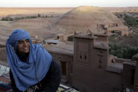 AFP A man wearing turban sits at a rooftop cafe.