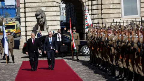 Reuters Hungarian Prime Minister Viktor Orban and Israeli Prime Minister Benjamin Netanyahu walk on the red carpet during a welcoming ceremony at the Lion's Courtyard in Budapest
